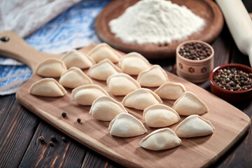 raw dumplings on the wooden board