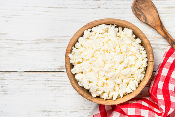 Curd or cottage cheese at wooden table.