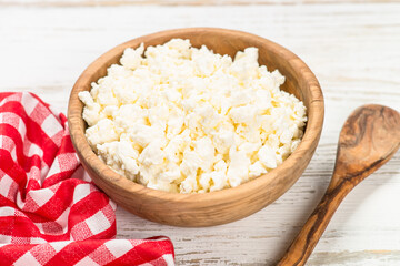 Curd or cottage cheese at wooden table.