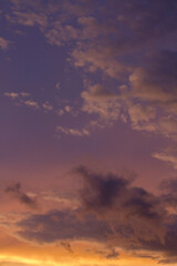 Magical sunset. Cloudscape. View of the dramatic sky and clouds during twilight with beautiful dusk colors, purple, orange and magenta. 