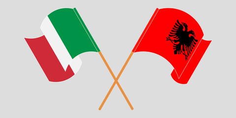Crossed and waving flags of Albania and Italy
