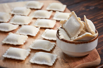 raw dumplings on teh wooden board