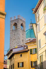 Dome of Santa Maria Assunta New Cathedral, Duomo Nuovo Roman Catholic church and Tower of Palazzo del Broletto palace, View between buildings , Brescia city historical centre, Lombardy, Northern Italy