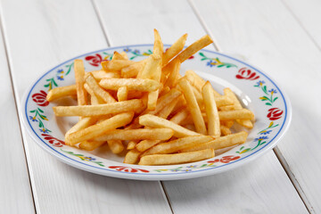 golden french fries on the wooden background