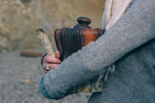 A Woman Holding an Urn of Ashes and Sage as Her Friend is Remembered