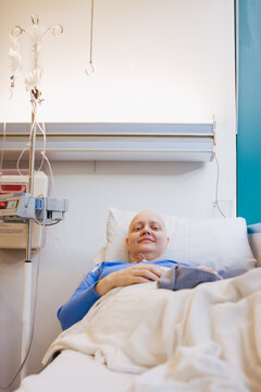 Woman smiles at the hospital during a round of chemotherapy, cancer treatment