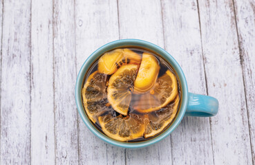 Mug with tea and lemon slices