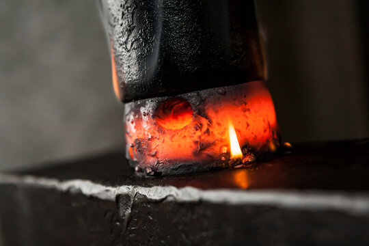 Hot metal crushed between hammer and anvil