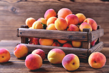 natural apricots in a wooden box on a natural wooden background, backlight soft focus