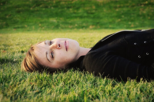 Young Woman Laying In Grass