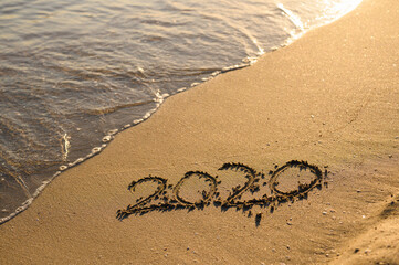 An inscription symbolizing 2020 on the seashore. The year of the worldwide coronavirus pandemic is...