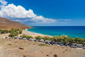 Photo sur Plexiglas Plage de Camps Bay, Le Cap, Afrique du Sud The amazing tropical beach of Panagia Tripiti, in Crete, with sandy beach, turquoise water and some lucky campers, Greece.
