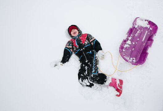 girl with sled in the snow