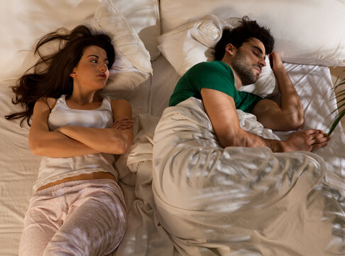 Young couple sleeping in their bed.