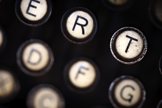 a close up of the keys of an old, antique, analog typewriter