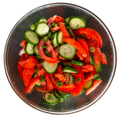 Isolate of a round dish with vitamin salad from fresh vegetables. Tomatoes, cucumbers, peppers, seasoned with oil. View from above.