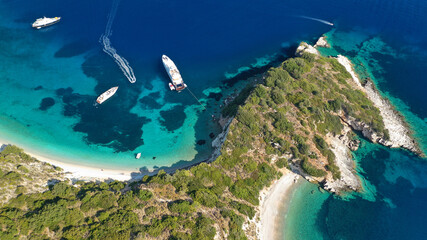 Aerial photo taken by drone of Caribbean tropical exotic steep cliff island bay with turquoise clear sea sandy beaches and rare limestone trees