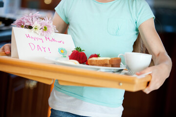 Mother's Day: Girl Carrying Tray with Breakfast For Mom