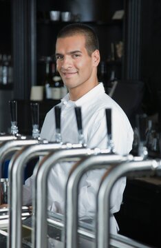 Portrait of smiling bartender in bar