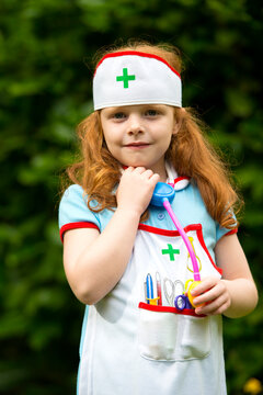 6 year old girl role playing as a nurse