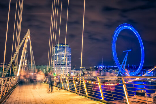 Bridge and Millenium Wheel in London by night