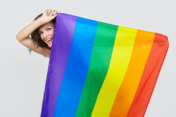 attractive brunette posing with the flag of the LGBT