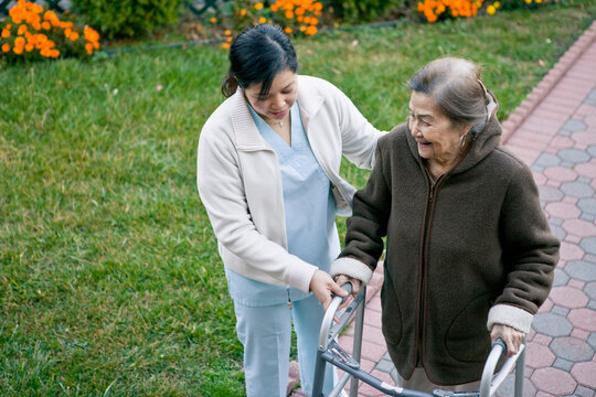 Homecare Provider Helps Elderly Patient Exercise with Walker