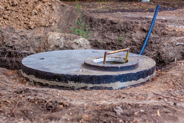 Sewer well. Installation and embedding of the sewer well in the ground is performed.