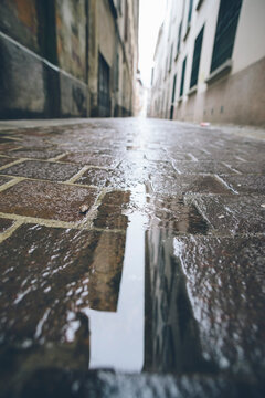 Puddle in empty street during a rainy day