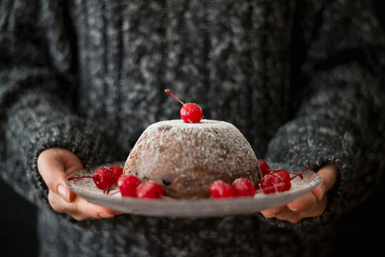 Woman serving Christmas pudding