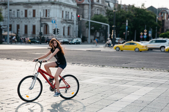 Preteenager girl riding a bike in the city