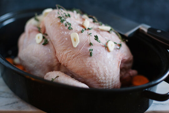 Preparing a roast chicken dinner with garlic and thyme.