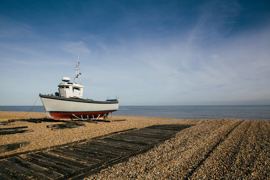 Fishing boat on an empty beach, Kent, UK.