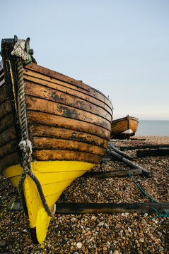 Traditional small wooden fishing boat on the shore.