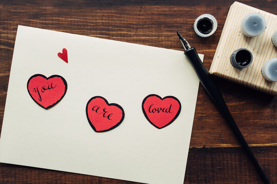 You are loved"" message and ink pen