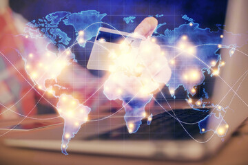 Double exposure of man hands holding a credit card and internet business theme drawing. Digital fintech and E-commerce concept.