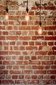 Fototapeta brick wall with 3 hanging pendant lights