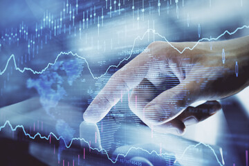 Multi exposure of man's hands holding and using a digital phone and forex graph drawing. Financial market concept.