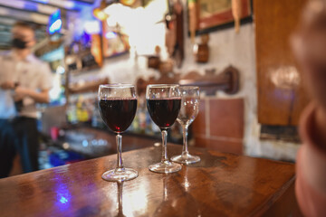 glasses filled with wine in an old bar