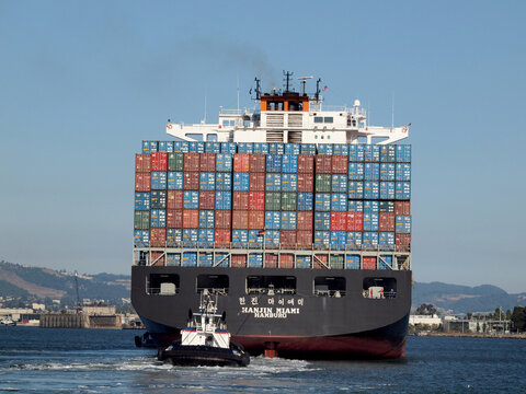 Hanjin Maimi Hamburg Cargo boat is pushed by Tugboat out of Oakland Harbor