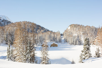 House set in a snowy landscape in the mountains