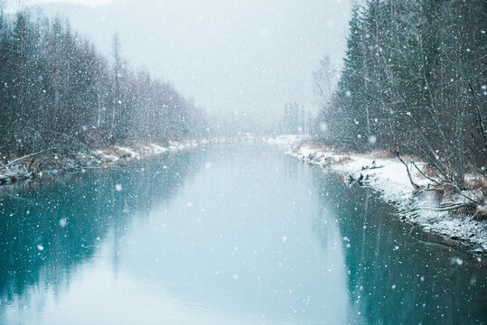 snow falling on a river