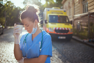 medical doctor woman with stethoscope, medical mask and coffee