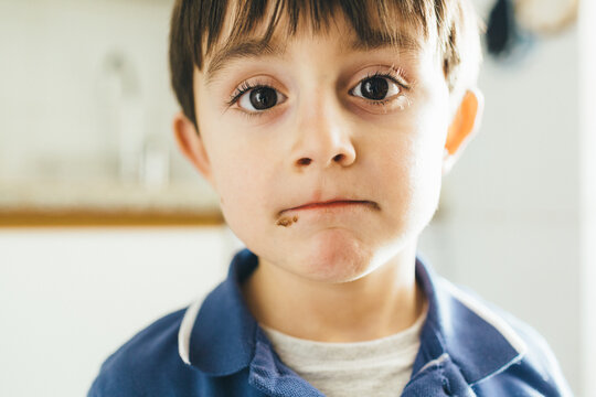 Portrait of kid with dirty mouth with chocolate