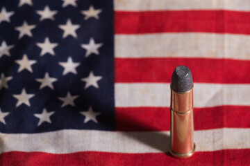 Single bullet on an old grungy US flag
