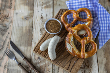Oktoberfest food. Bavarian meal . White sausages, brezel and sweet mustard on wooden table