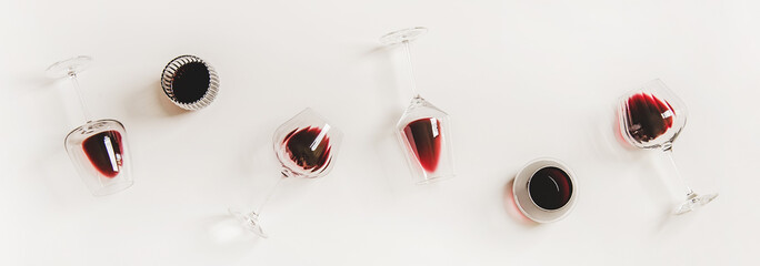 Red wine in glasses. Flat-lay of wine glasses with red wine in row over plain white background, top view. Wine tasting, winery, bar or Beaujolais Nouveau concept - obrazy, fototapety, plakaty
