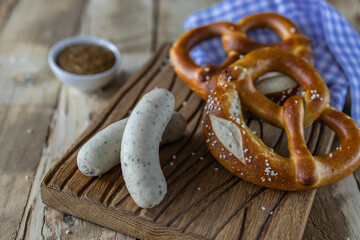 Oktoberfest food. Bavarian meal . White sausages, brezel and sweet mustard on wooden table