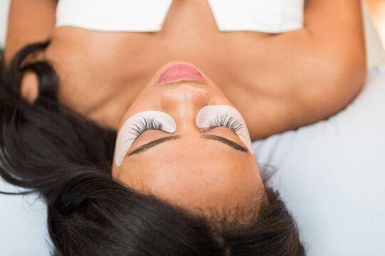 A young black woman with lash extensions in a salon