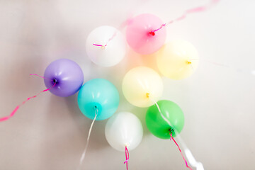 looking up at multicolored balloons on a ceiling